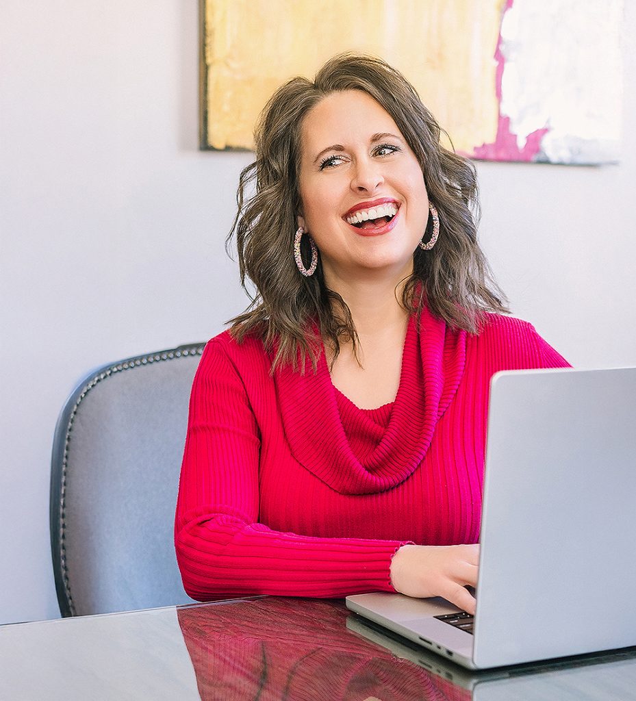 Oklahoma City branding photography of professional woman smiling while working on laptop at desk