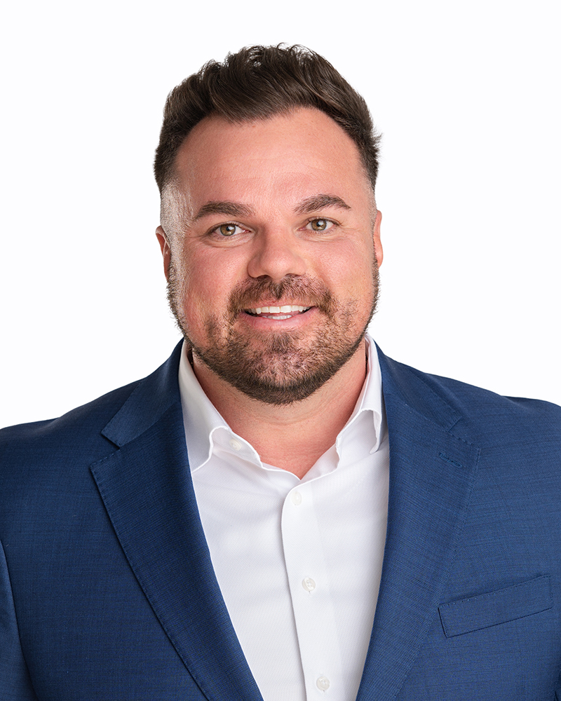Professional headshot of Tim Branch, real estate investor and co-founder of a husband-and-wife investment team focused on residential property investments.