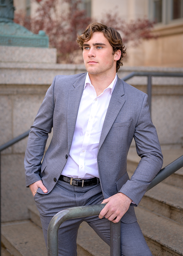 Jack casually leaning on a railing for his Edmond, OK senior pictures.