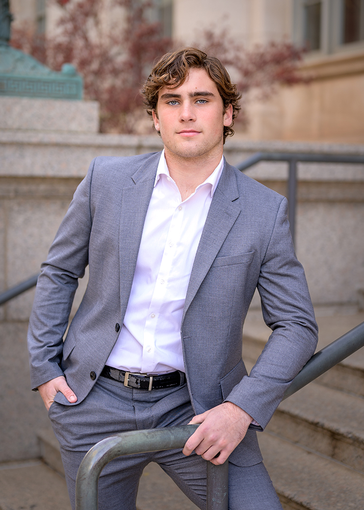 Jack casually leaning on a railing for his Edmond, OK senior pictures.