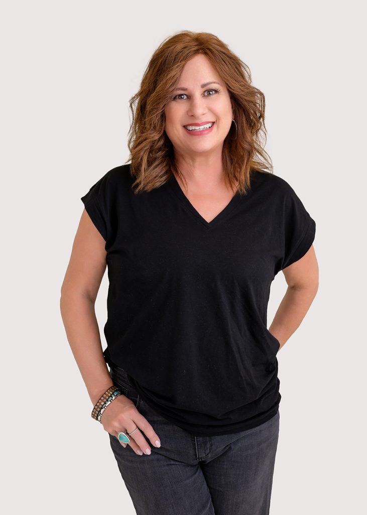 a person in a black t - shirt and jeans posing for the camera