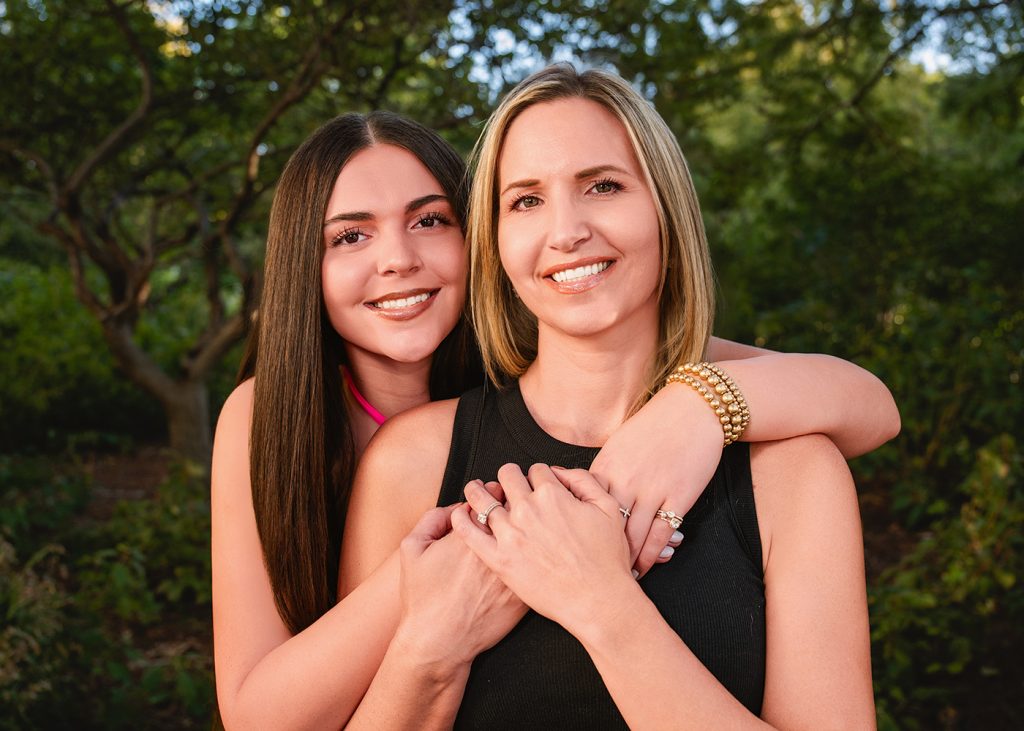 Peyton's senior photo session at the Myriad Gardens in OKC. Peyton and her mom embrace for a mother-daughter photo.
