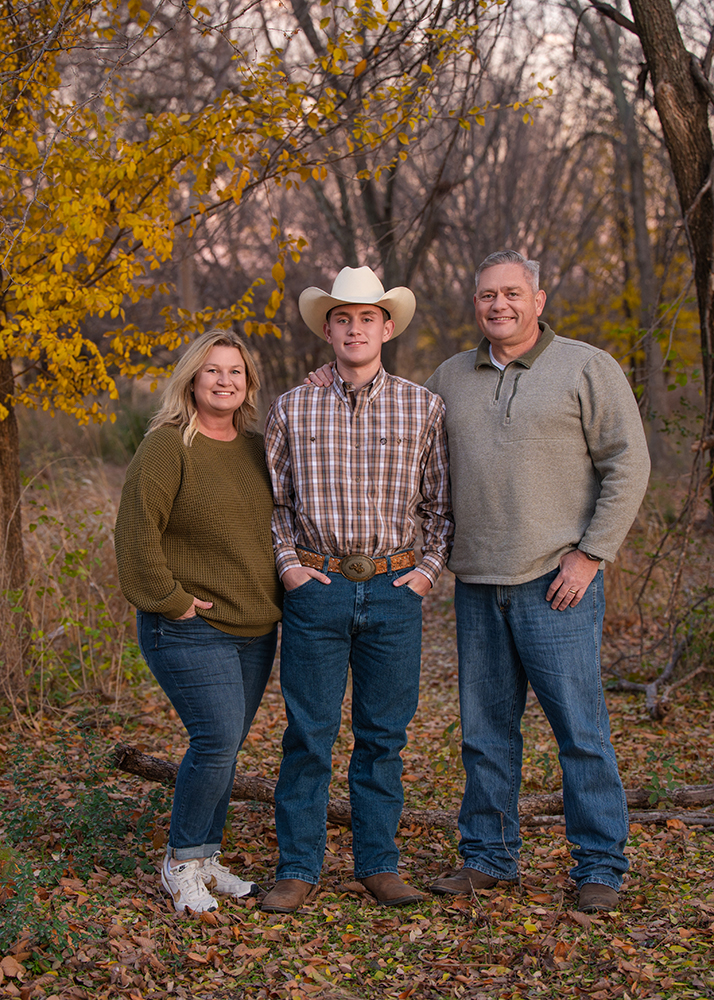 High school senior with his parents during his senior portrait session.