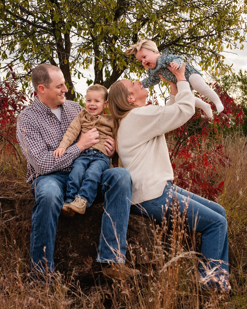 Family laughing together during outdoor family photo session in Edmond Oklahoma