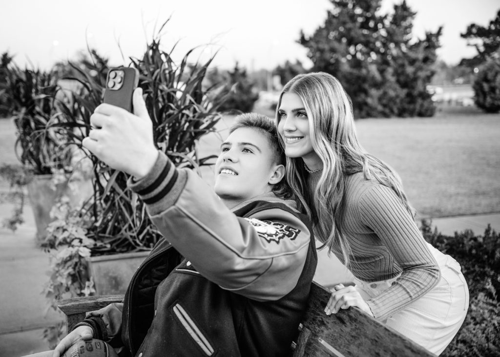 High school seniors taking a selfie together during Oklahoma City senior portrait session with friends