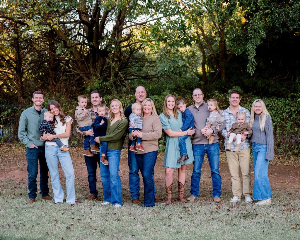 Large extended family gathered together for an outdoor family portrait session in Edmond, Oklahoma.