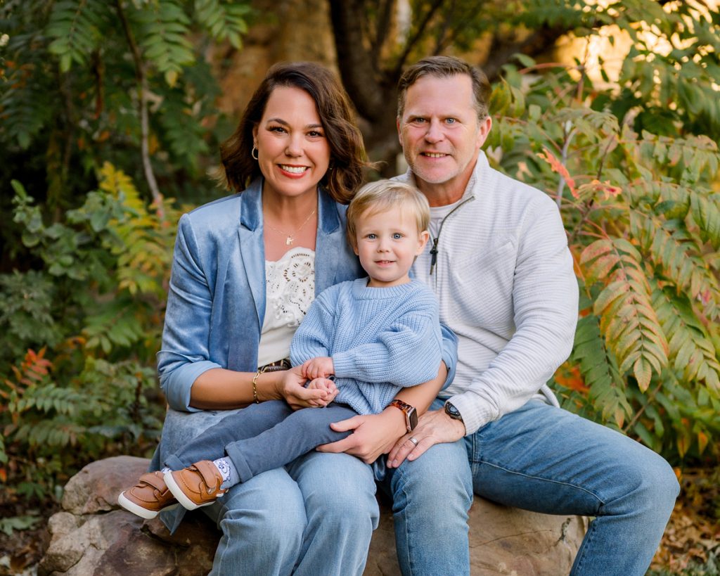 Grandarents and young grandson posing together during a fall family photo session in Edmond