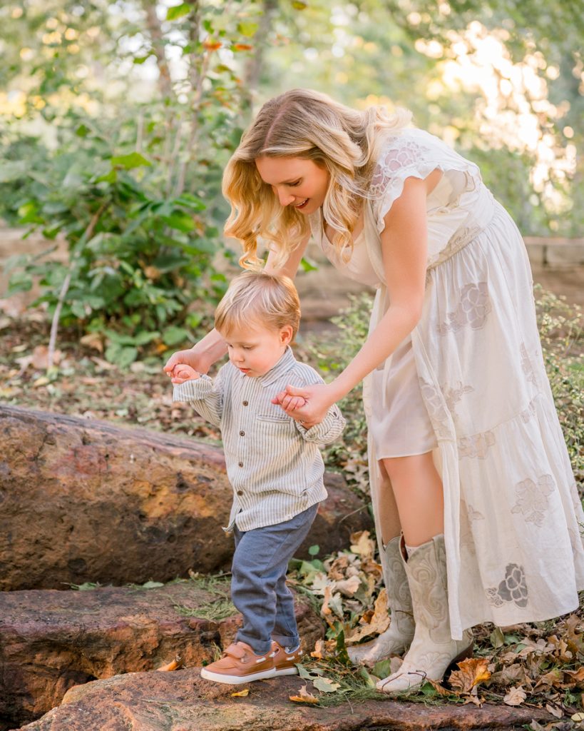 Mother helping her toddler explore during a family photo session in Edmond