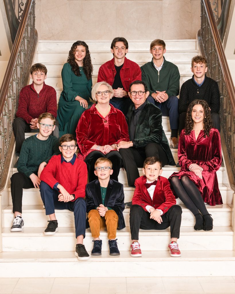 Large family dressed in coordinated outfits for a formal portrait session