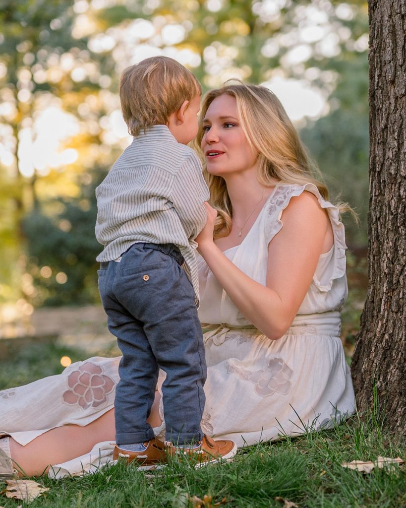Mother interacting with her toddler during an outdoor portrait session in Edmond