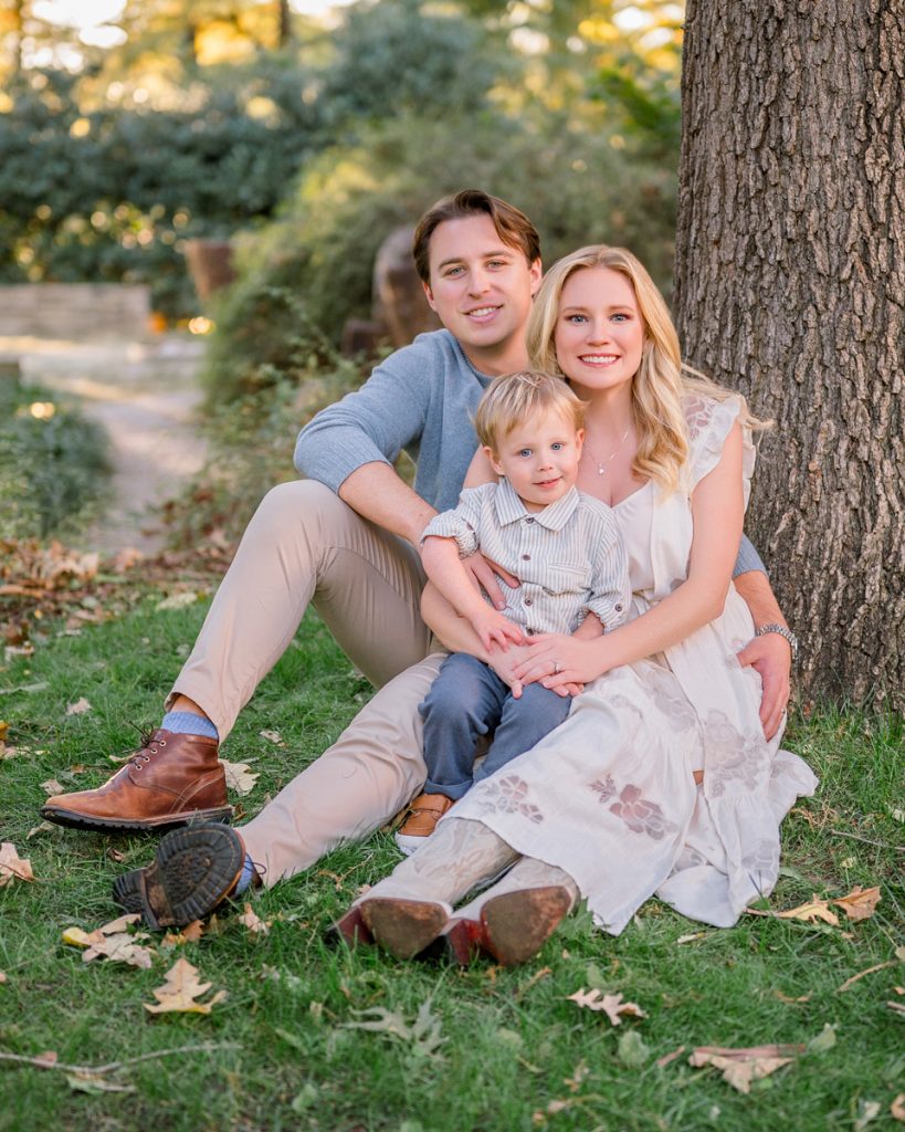 Young family sitting together outdoors during a relaxed portrait session